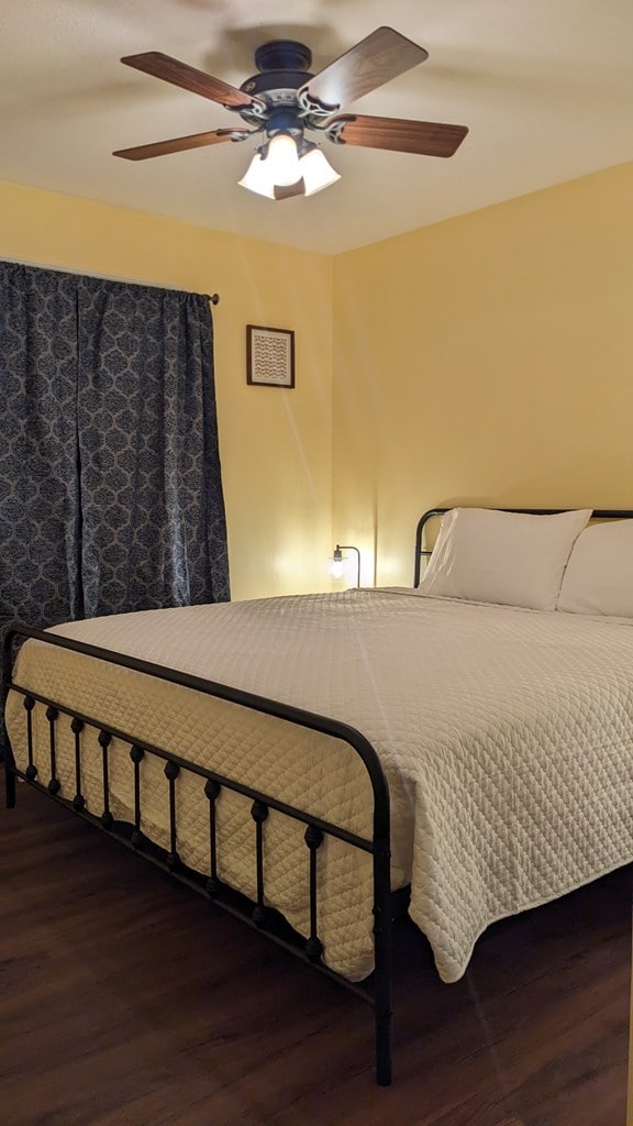 bedroom featuring hardwood / wood-style flooring and ceiling fan