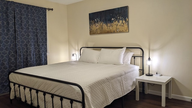 bedroom featuring dark hardwood / wood-style flooring