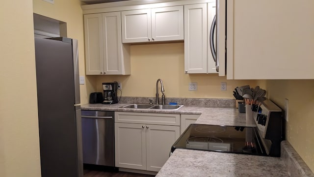 kitchen with sink, white cabinetry, and stainless steel appliances