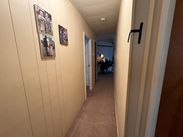 hall with light colored carpet