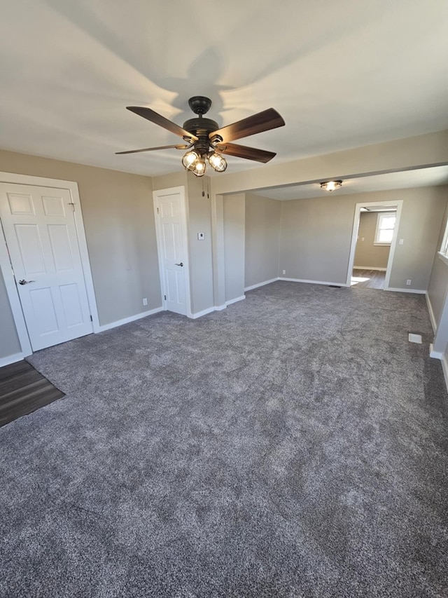unfurnished bedroom featuring dark colored carpet and ceiling fan