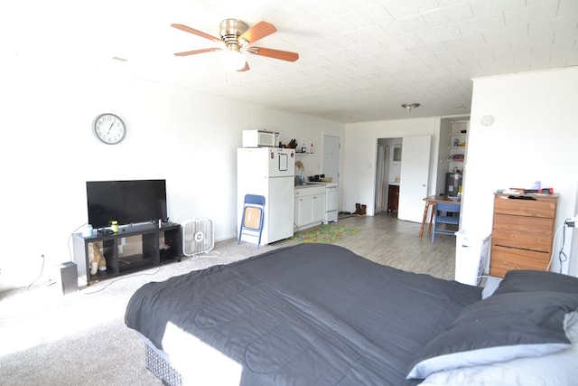 bedroom featuring freestanding refrigerator and a ceiling fan