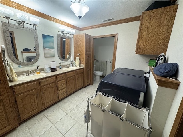 bathroom with crown molding, vanity, and toilet