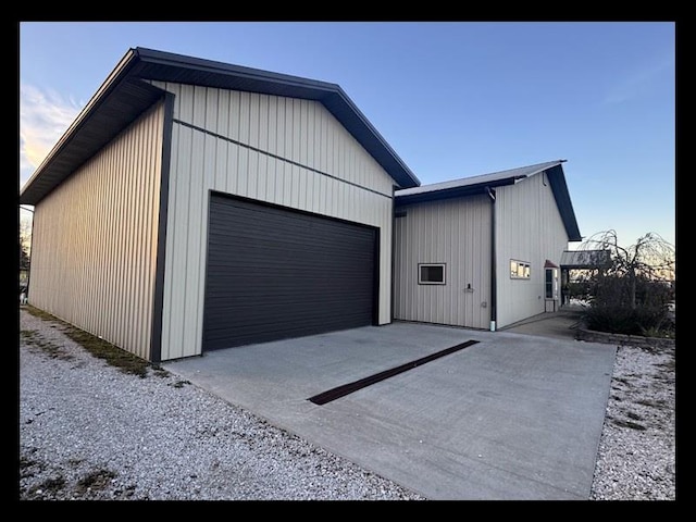 view of garage at dusk