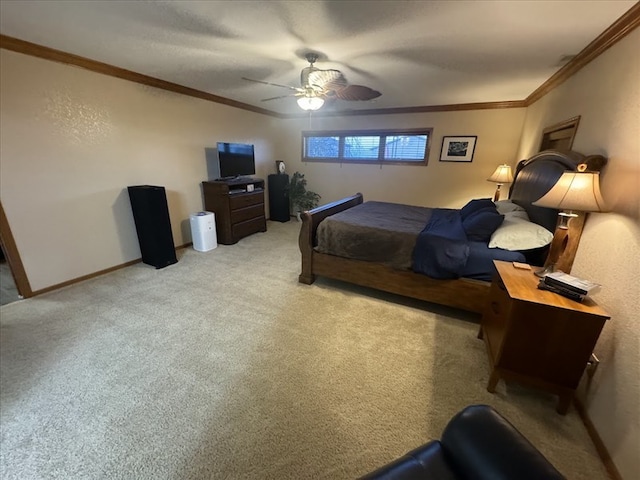 carpeted bedroom featuring ceiling fan and crown molding