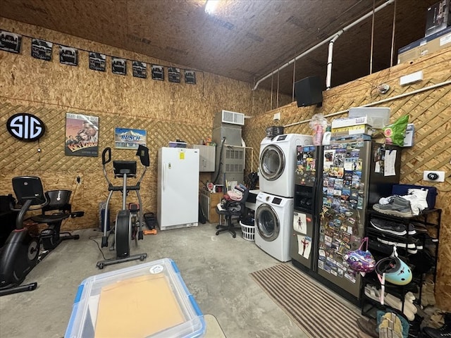 clothes washing area with stacked washer and clothes dryer