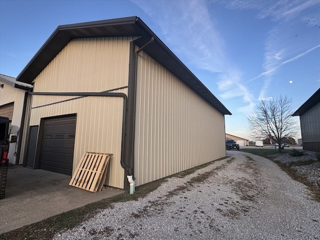 view of side of home featuring a garage and an outdoor structure