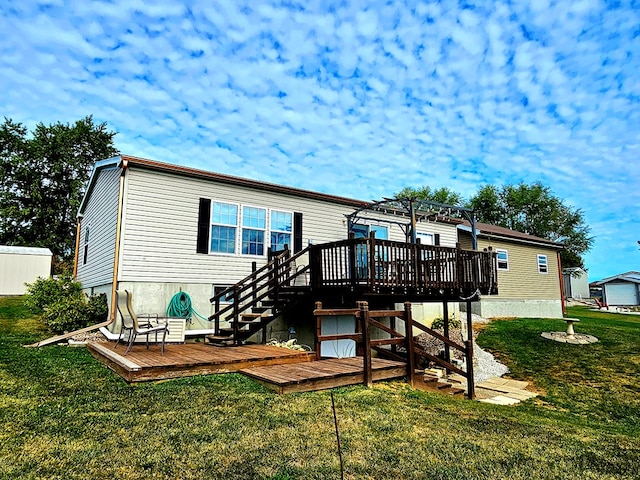 rear view of house featuring a lawn, a wooden deck, and a pergola