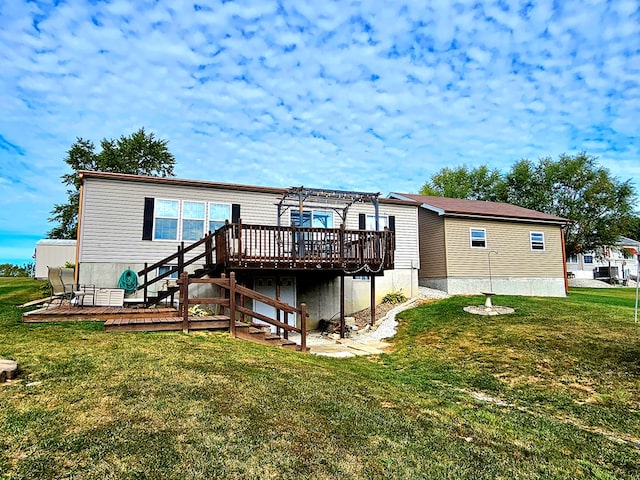 back of property featuring a yard, a pergola, and a wooden deck