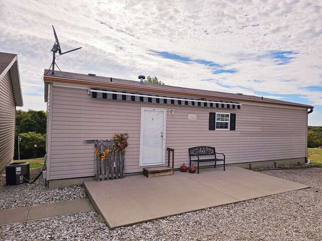 back of house with a patio and central AC unit