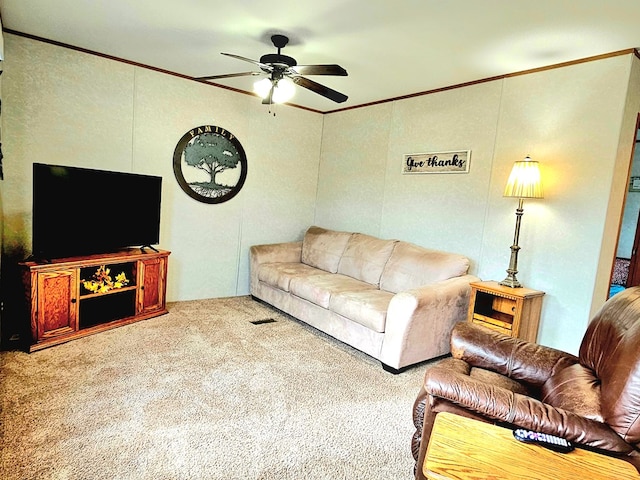 carpeted living room featuring ceiling fan and crown molding