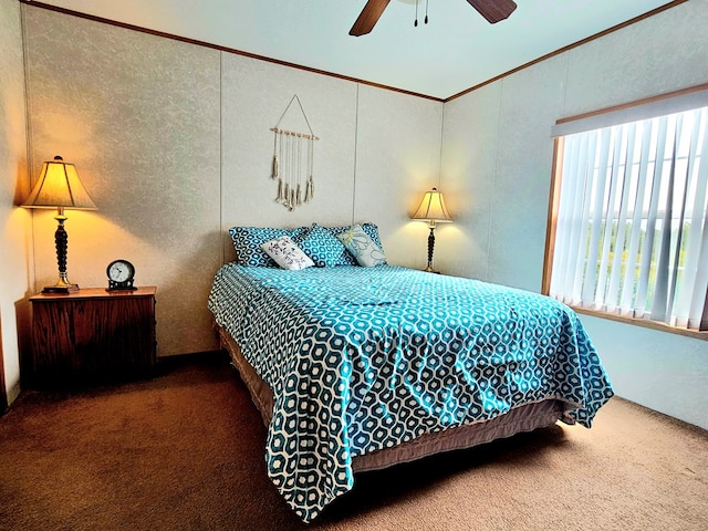 bedroom featuring ceiling fan, carpet floors, and ornamental molding