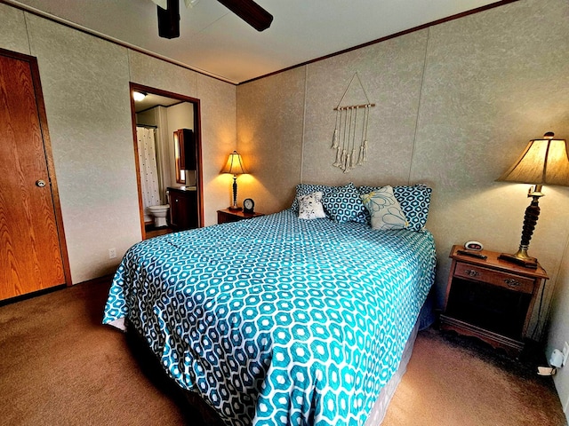 bedroom featuring ceiling fan, ensuite bathroom, carpet floors, and crown molding