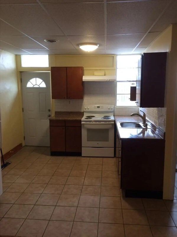 115, 117 N Rollins St, Macon, MO 63552 - kitchen with a paneled ceiling, a sink, light tile patterned flooring, under cabinet range hood, and white range with electric cooktop
