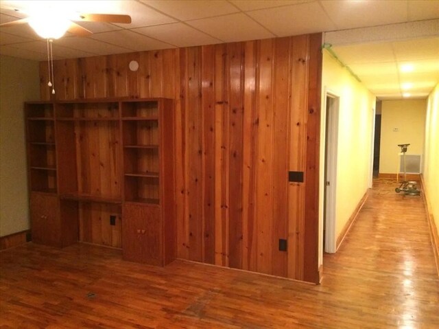 115, 117 N Rollins St, Macon, MO 63552 - interior space with wooden walls, wood finished floors, and ceiling fan