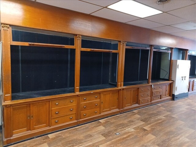 115, 117 N Rollins St, Macon, MO 63552 - unfurnished living room featuring a paneled ceiling and light wood-style flooring