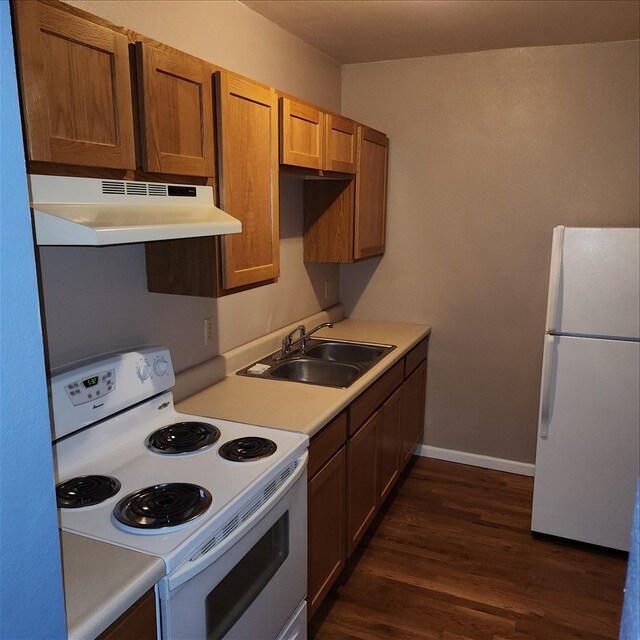 115, 117 N Rollins St, Macon, MO 63552 - kitchen with a sink, white appliances, light countertops, dark wood finished floors, and under cabinet range hood