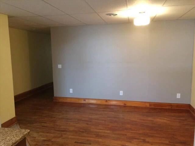 115, 117 N Rollins St, Macon, MO 63552 - unfurnished room featuring baseboards, a paneled ceiling, and wood finished floors