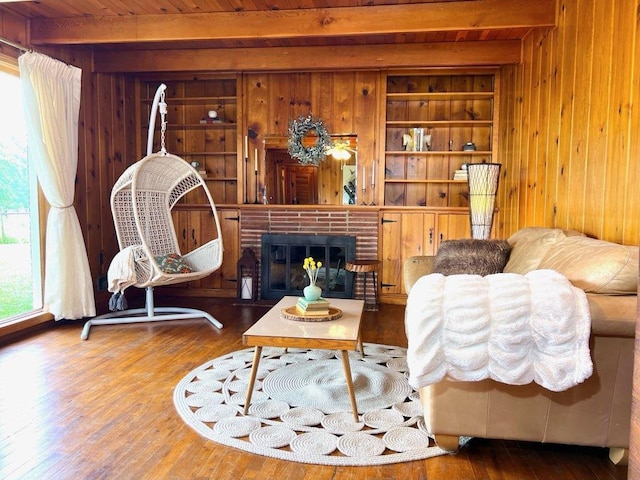 64234 Hwy 6, Green Castle, MO 63544 - living area featuring wooden walls, built in shelves, wood finished floors, a brick fireplace, and a wood ceiling with exposed beams