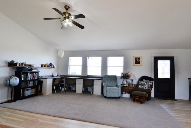 office space featuring a ceiling fan, wood finished floors, and lofted ceiling