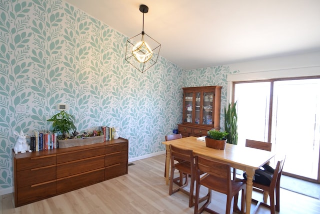 dining area with wallpapered walls, a wealth of natural light, and light wood-style flooring