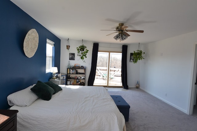 bedroom with baseboards, a ceiling fan, multiple windows, and access to exterior