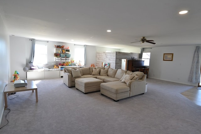 living area with light colored carpet, recessed lighting, ceiling fan, and a wealth of natural light