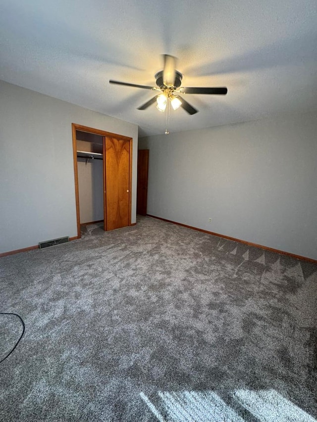 unfurnished bedroom with baseboards, a textured ceiling, visible vents, and a closet