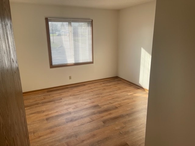 1302 Queens Ct, Kirksville, MO 63501 - unfurnished room with wood finished floors and baseboards