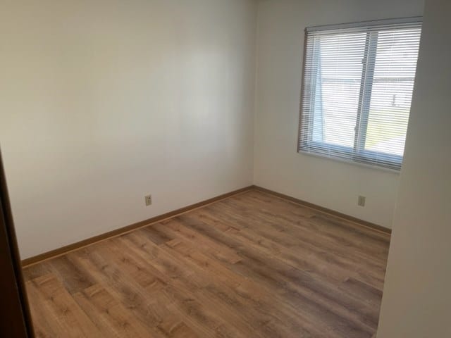 1302 Queens Ct, Kirksville, MO 63501 - spare room with wood finished floors and baseboards