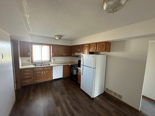 1302 Queens Ct, Kirksville, MO 63501 - kitchen featuring white appliances, a textured ceiling, light countertops, dark wood-style flooring, and extractor fan