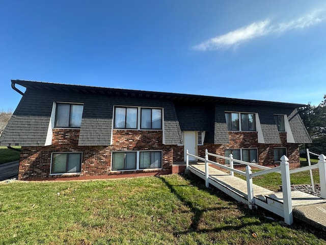 1302 Queens Ct, Kirksville, MO 63501 - rear view of property featuring brick siding and a lawn