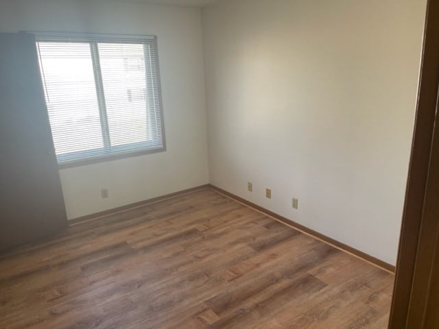 1302 Queens Ct, Kirksville, MO 63501 - unfurnished room featuring wood finished floors and baseboards