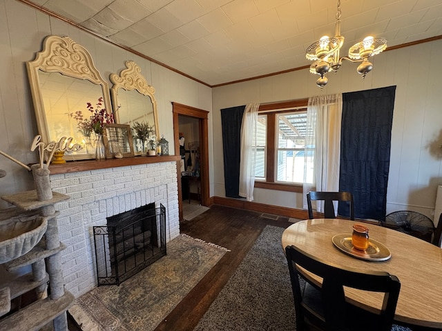 616 E Jefferson St, Kirksville, MO 63501 - living area with a brick fireplace, ornamental molding, wood finished floors, and a chandelier