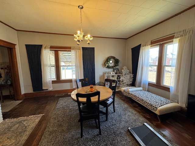 616 E Jefferson St, Kirksville, MO 63501 - dining area with a notable chandelier, wood finished floors, baseboards, and ornamental molding