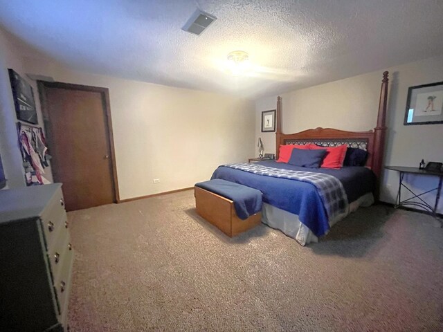 bedroom with carpet, a textured ceiling, and visible vents