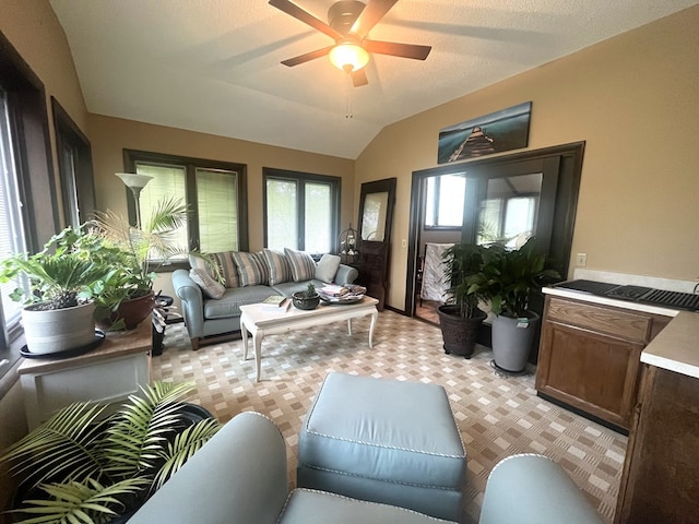 living area with a ceiling fan, light colored carpet, and vaulted ceiling