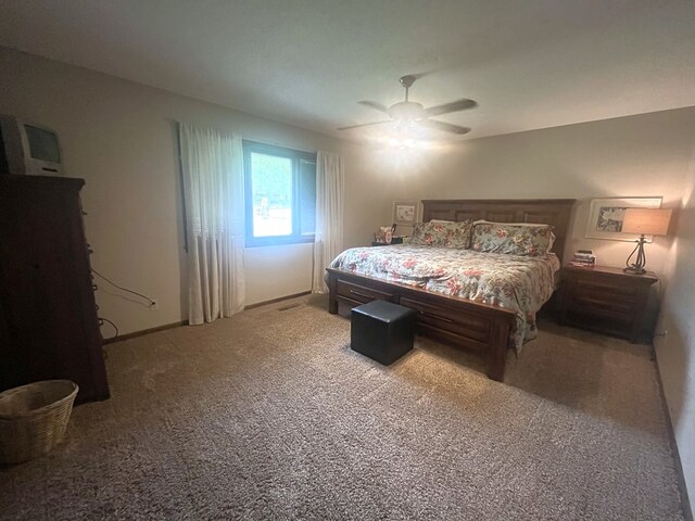 carpeted bedroom featuring baseboards and ceiling fan