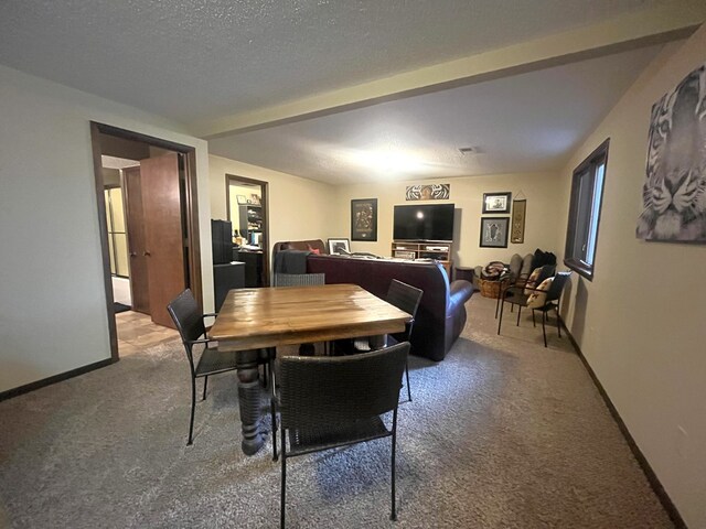 carpeted dining room featuring baseboards