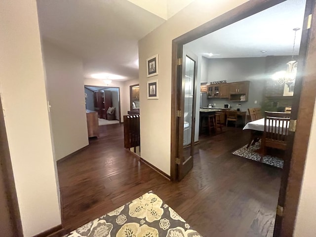 hall with baseboards and dark wood-type flooring