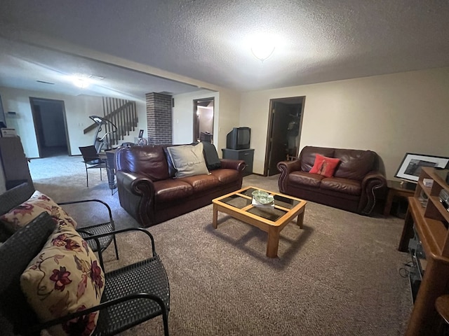 living room featuring stairway, carpet flooring, and a textured ceiling