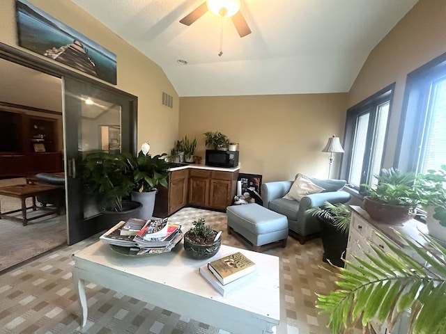 interior space with visible vents, a ceiling fan, light colored carpet, and lofted ceiling