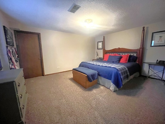bedroom with carpet floors, a textured ceiling, and visible vents