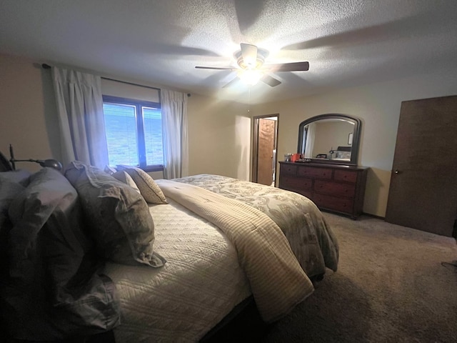 bedroom with a ceiling fan, a textured ceiling, and light colored carpet