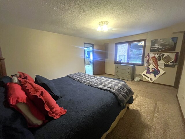 bedroom featuring a textured ceiling and carpet