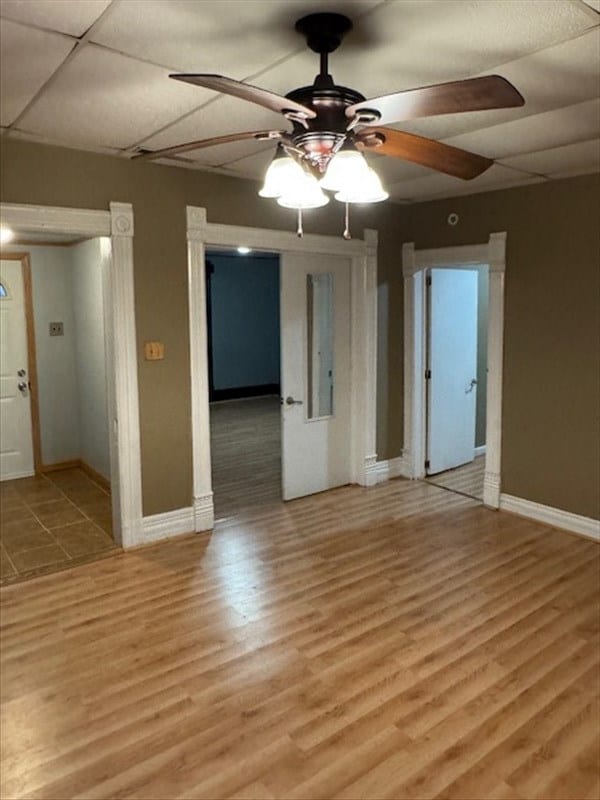 empty room with ceiling fan and light wood-type flooring