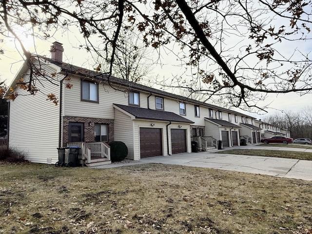 exterior space with a yard and a garage