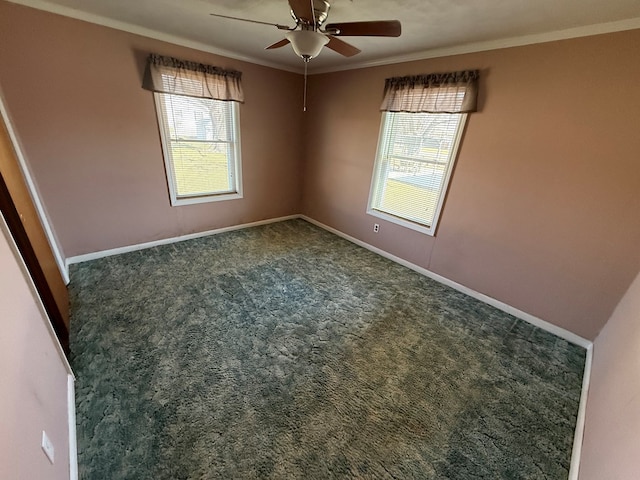 carpeted empty room featuring a healthy amount of sunlight, baseboards, and ornamental molding