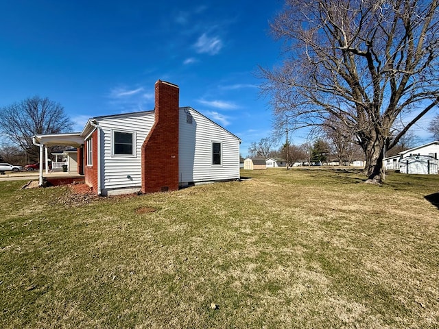 rear view of house featuring crawl space, a lawn, and a chimney