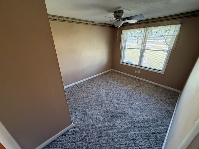 spare room with carpet flooring, a ceiling fan, and baseboards